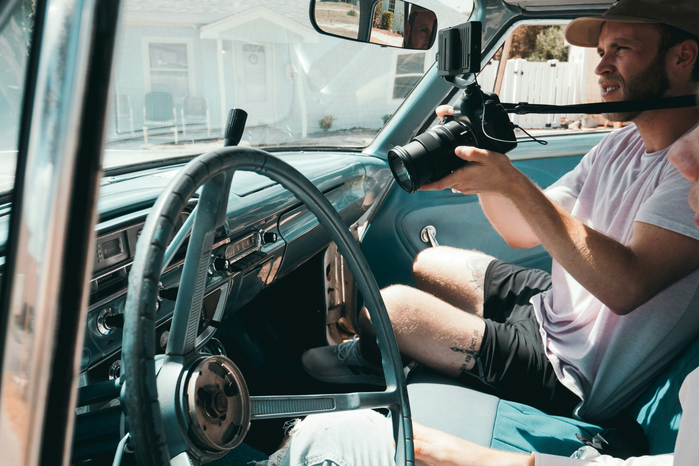 person inside vehicle holding camera